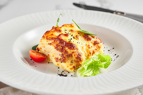 Lasagna with tomato and green leaf