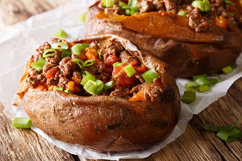 Organic food: baked sweet potato stuffed with ground beef and gr